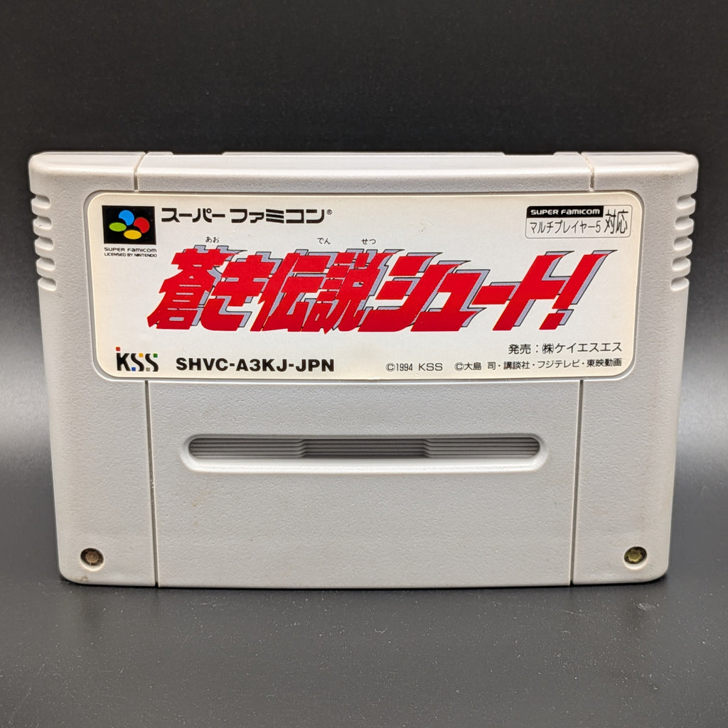 A close up of Aoki Densetsu Shoot video game cartridge for Nintendo's Super Famicom (SFC) Entertainment System, shown standing up and facing forward on a dark grey background.
