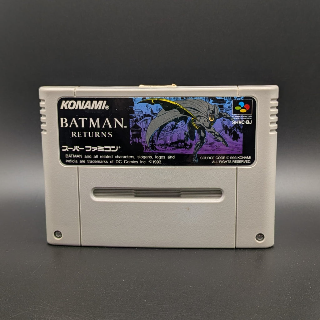 Batman Returns video game cartridge for Nintendo's Super Famicom (SFC) Entertainment System, shown standing up and facing forward on a dark grey background.
