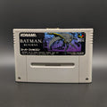 Batman Returns video game cartridge for Nintendo's Super Famicom (SFC) Entertainment System, shown standing up and facing forward on a dark grey background.
