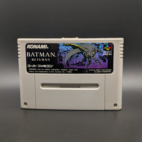 Batman Returns video game cartridge for Nintendo's Super Famicom (SFC) Entertainment System, shown standing up and facing forward on a dark grey background.
