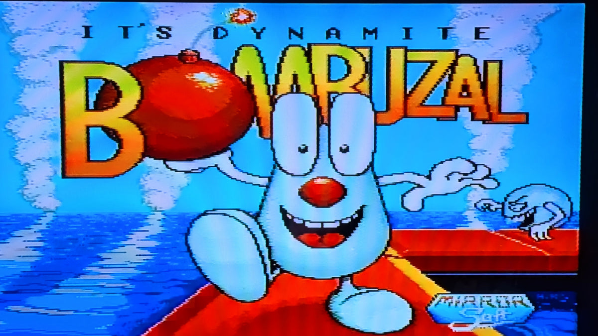 Digital title screen for Bombzal, featuring text  "Its Dynamite Bombuzal" at the top, with the blue cartoon character Bombzal on a red platform against a blue water background. This shows the game in working order.
