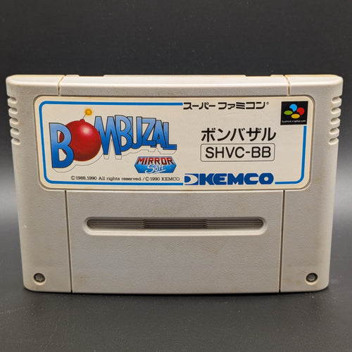 A close up of Bombuzal video game cartridge for Nintendo's Super Famicom (SFC) Entertainment System, shown standing up and facing forward on a dark grey background.