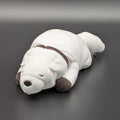 A plush Bond Forger dog toy shown lying on its belly, facing forwards at 3/4 view angle. Sitting on a dark grey surface, with soft white fur and brownish grey accents on its paws, snout, and collar. From the anime/manga series Spy X Family, made by Club Mochi-Mochi.