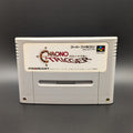 Chrono Trigger video game cartridge for Nintendo's Super Famicom (SFC) Entertainment System, shown standing up and facing forward on a dark grey background.
