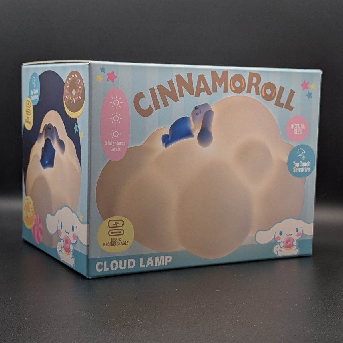 A Cinnamoroll Cloud Lamp toy in its original packaging, featuring a light blue box with a large illustration of the cloud-shaped lamp and Cinnamoroll character graphics.