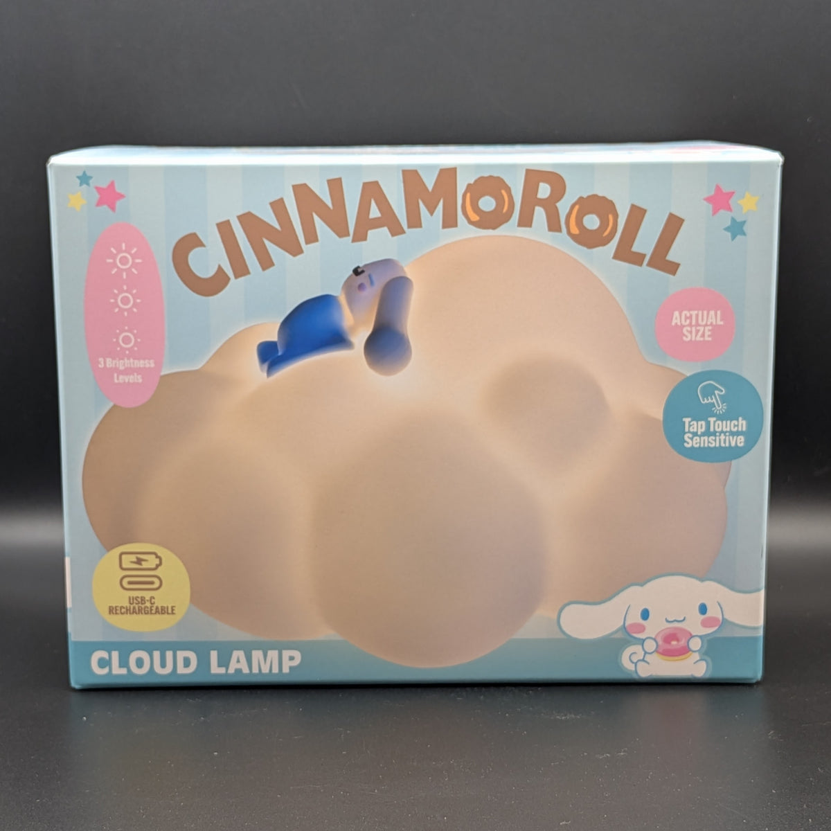 Cinnamoroll cloud-shaped LED night light in its original packaging, featuring a light blue box with illustrations of Cinnamoroll and product feature callouts.