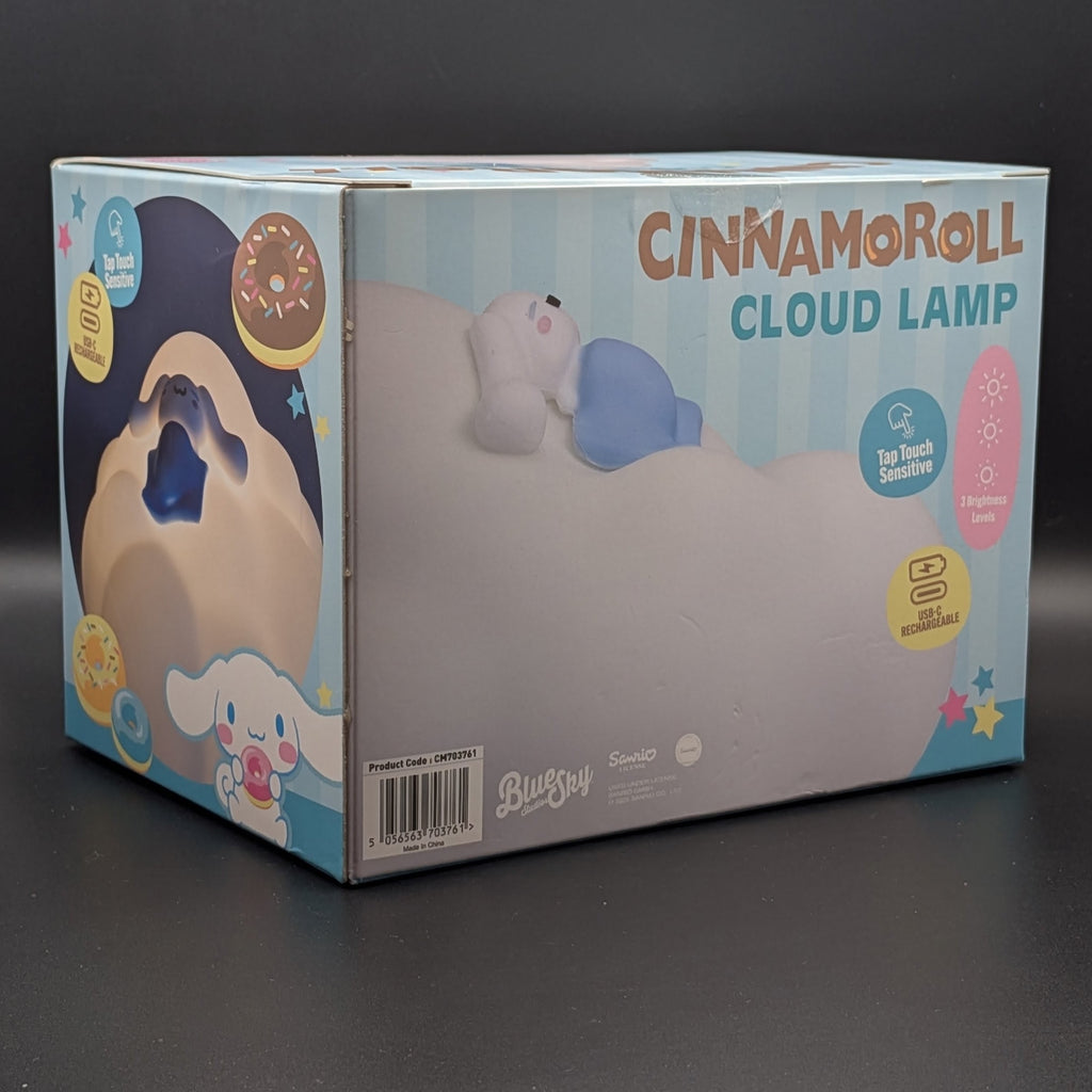 Cinnamoroll Cloud Lamp retail packaging box, featuring illustrations of the character and product details, photographed on a dark gray surface.