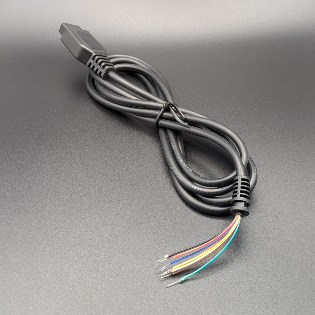 A shot of a black multi-pin electrical connector cable, resting on a textured gray surface with 9 coloured tails.