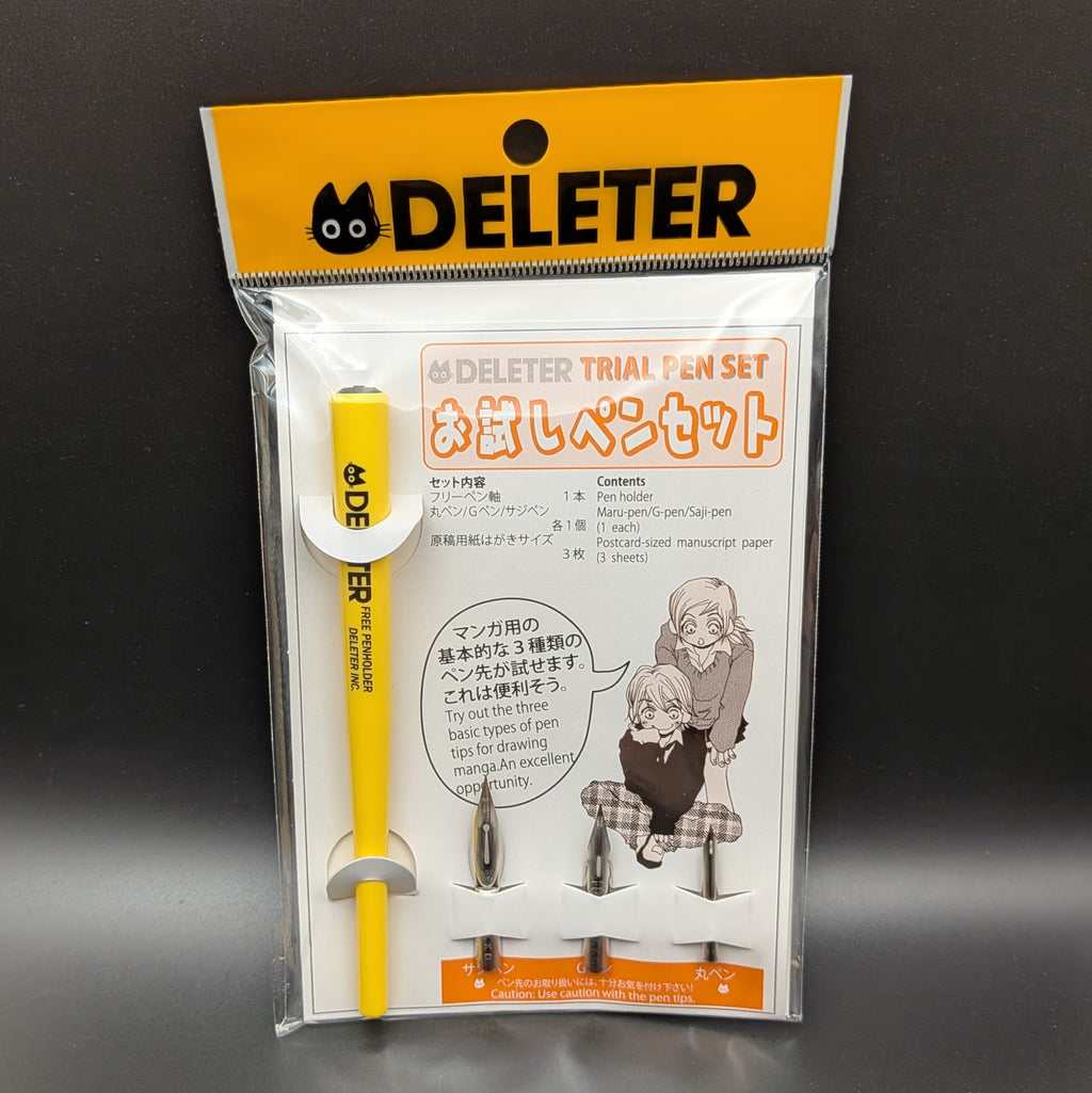 DELETER Trial Pen Set in its original retail packaging, featuring a yellow pen, 3 pen nibs, manuscript paper, with a white and orange card insert. Taken on a black background