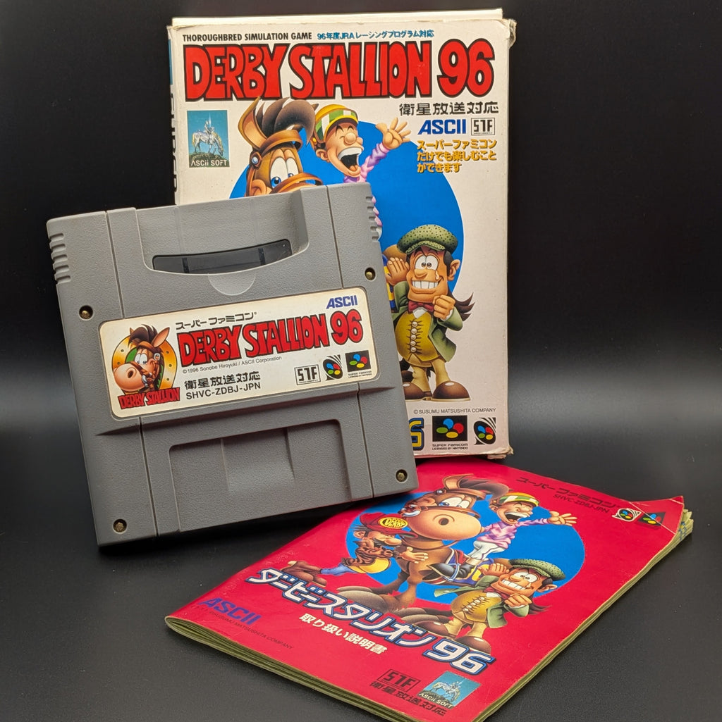 Derby Stallion 96 video game cartridge for Nintendo's Super Famicom (SFC) Entertainment System, shown standing up, in front of its box and the manual peaking out from beneath the two. Displayed on a dark grey background.
