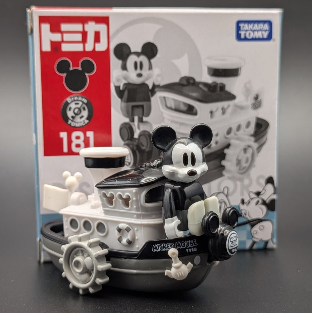 Tomica Mickey Mouse Model 181 toy Boat in front of its original Takara Tomy packaging box, featuring a black and white retro design.