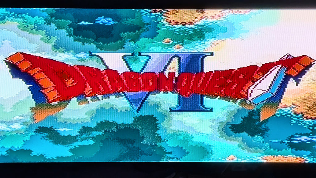 The game title screen shows Dragon Ball VI logo in pixelated retro style over a blue and teal oceans and bits of land mass and clouds filling the background. This is to show the Super famicom (SFC) game works.
