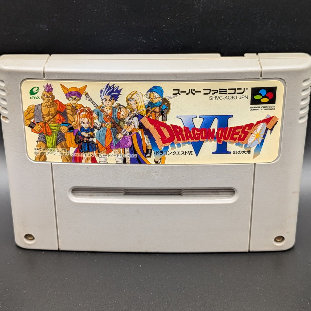A close up of Dragon Quest VI video game cartridge for Nintendo's Super Famicom (SFC) Entertainment System, shown standing up and facing forwards on a dark grey background.