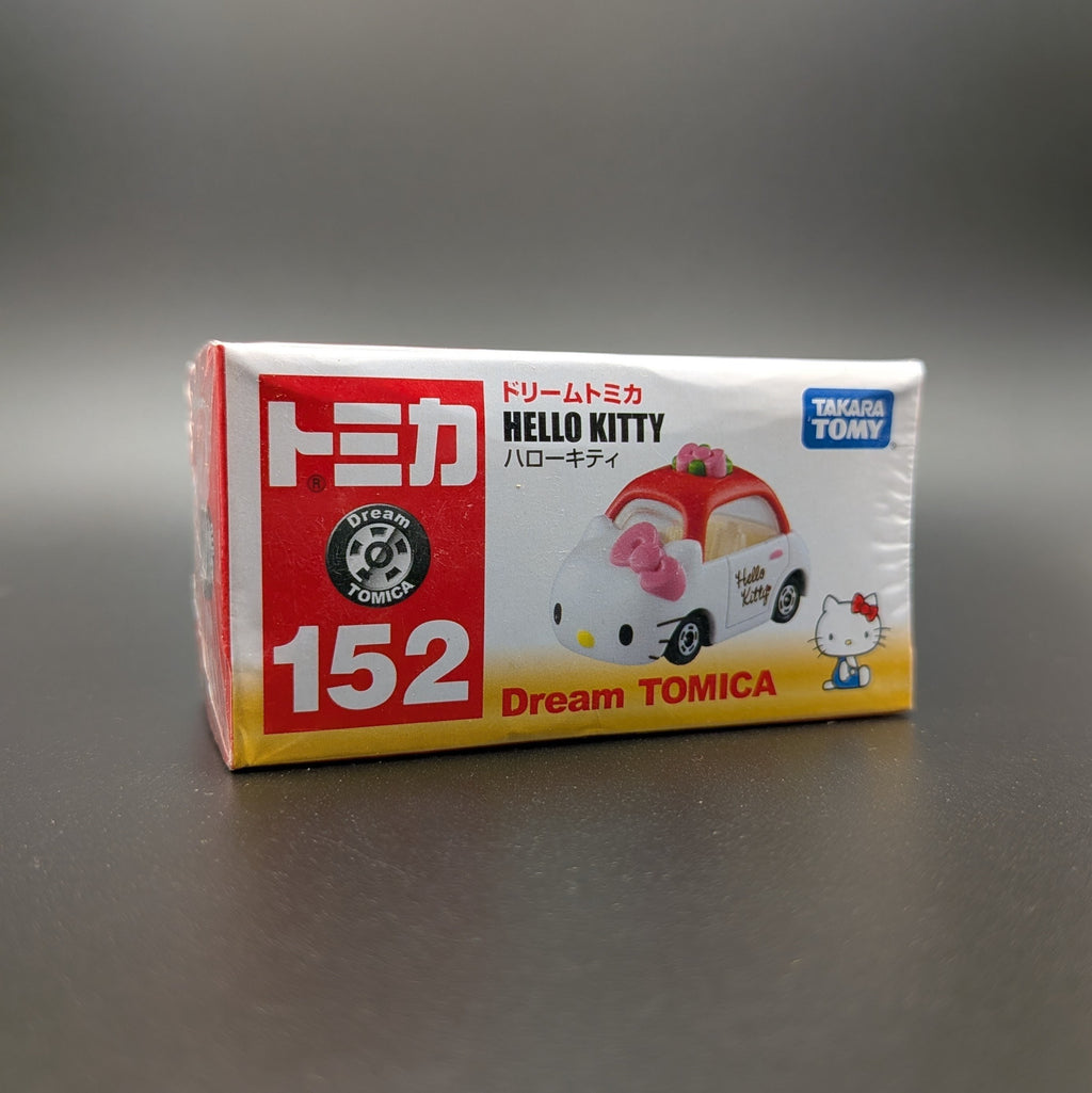Dream TOMICA Hello Kitty toy car packaging on a gray background
