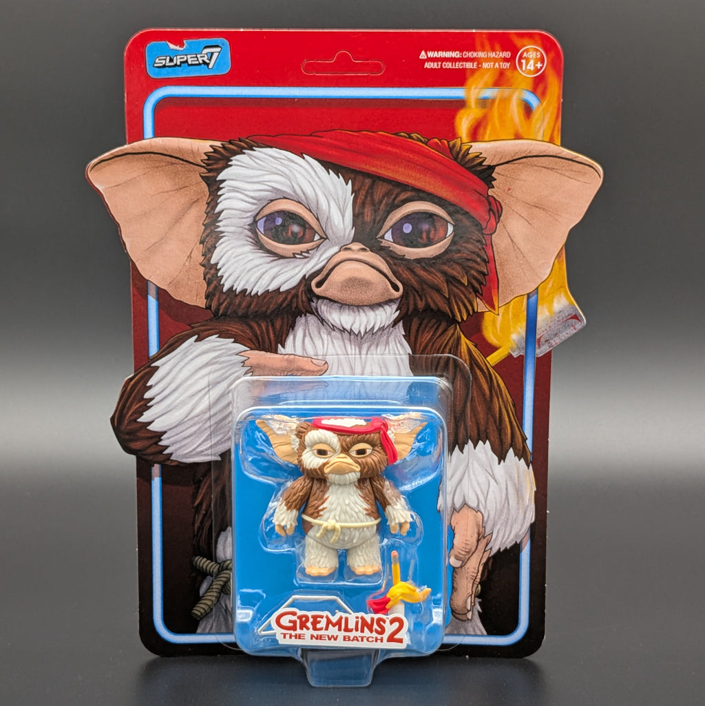 Super7 Gremlins 2 The New Batch action figure in its original blister card packaging, featuring a detailed Gremlin illustration on the backing card and the small figure with a red headband in the clear blister.