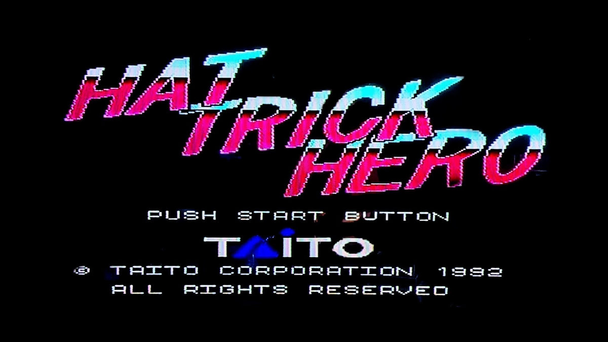 The digital game title screen for 'Hat Trick Hero' on a black background, with stylised pink, cyan, and purple text, the Taito logo, and white text reading 'PUSH START BUTTON' and '© TAITO CORPORATION 1982'. Released by Nintendo for the Super Famicom (SFC).