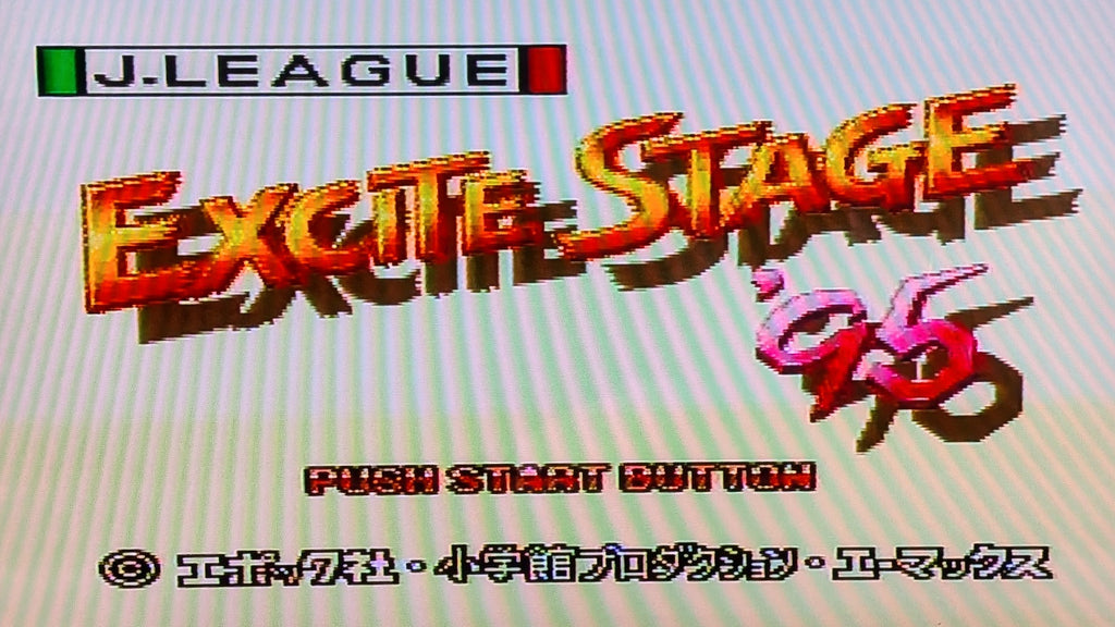 The game title screen for J.League Excite Stage '95  for Nintendo's Super Famicom (SFC), featuring stylized 3D text and game branding on a pale striped background. This is to show the game is tested and working.