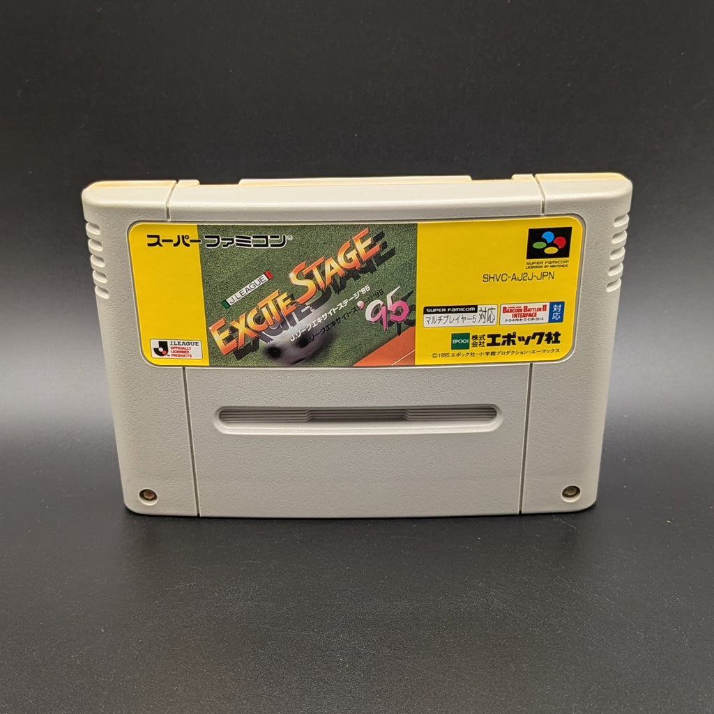 J-League Excite Stage '95 video game cartridge for Nintendo's Super Famicom (SFC) Entertainment System, shown standing up and facing forward on a dark grey background.