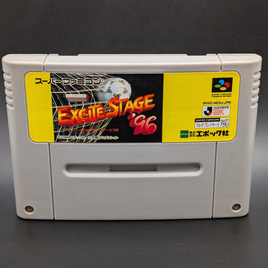 A close up of  front of the game, J.League Excite Stage '96 video game cartridge for the Super Famicom Entertainment System, shown standing up and facing forward on a dark grey background.
