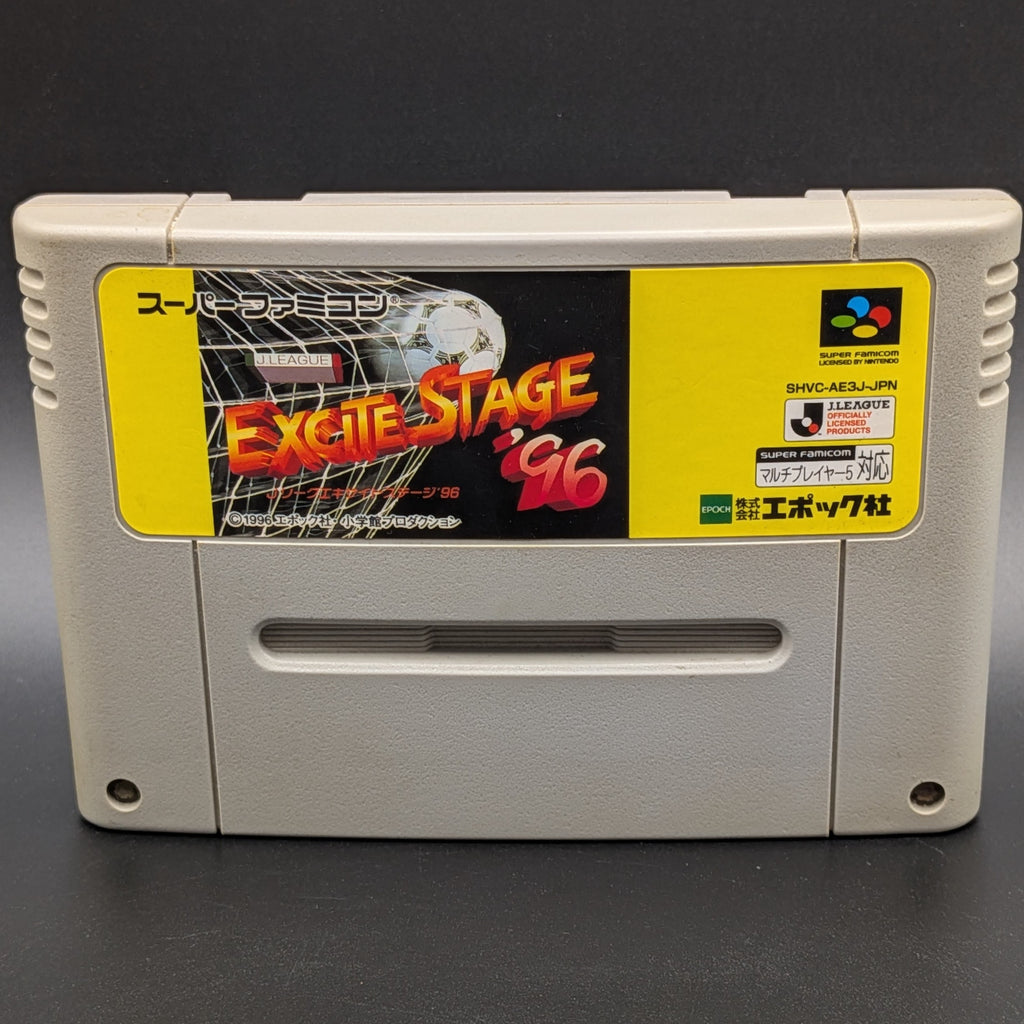 A close up of J League Excite Stage '96 video game cartridge for Nintendo's Super Famicom (SFC) Entertainment System, shown standing up and facing forward on a dark grey background.