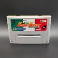 J League Super Soccer video game cartridge for Nintendo's Super Famicom (SFC) Entertainment System, shown standing up and facing forwards on a dark grey background.
