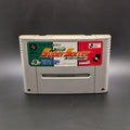J League Super Soccer video game cartridge for Nintendo's Super Famicom (SFC) Entertainment System, shown standing up and facing forward on a dark grey background.
