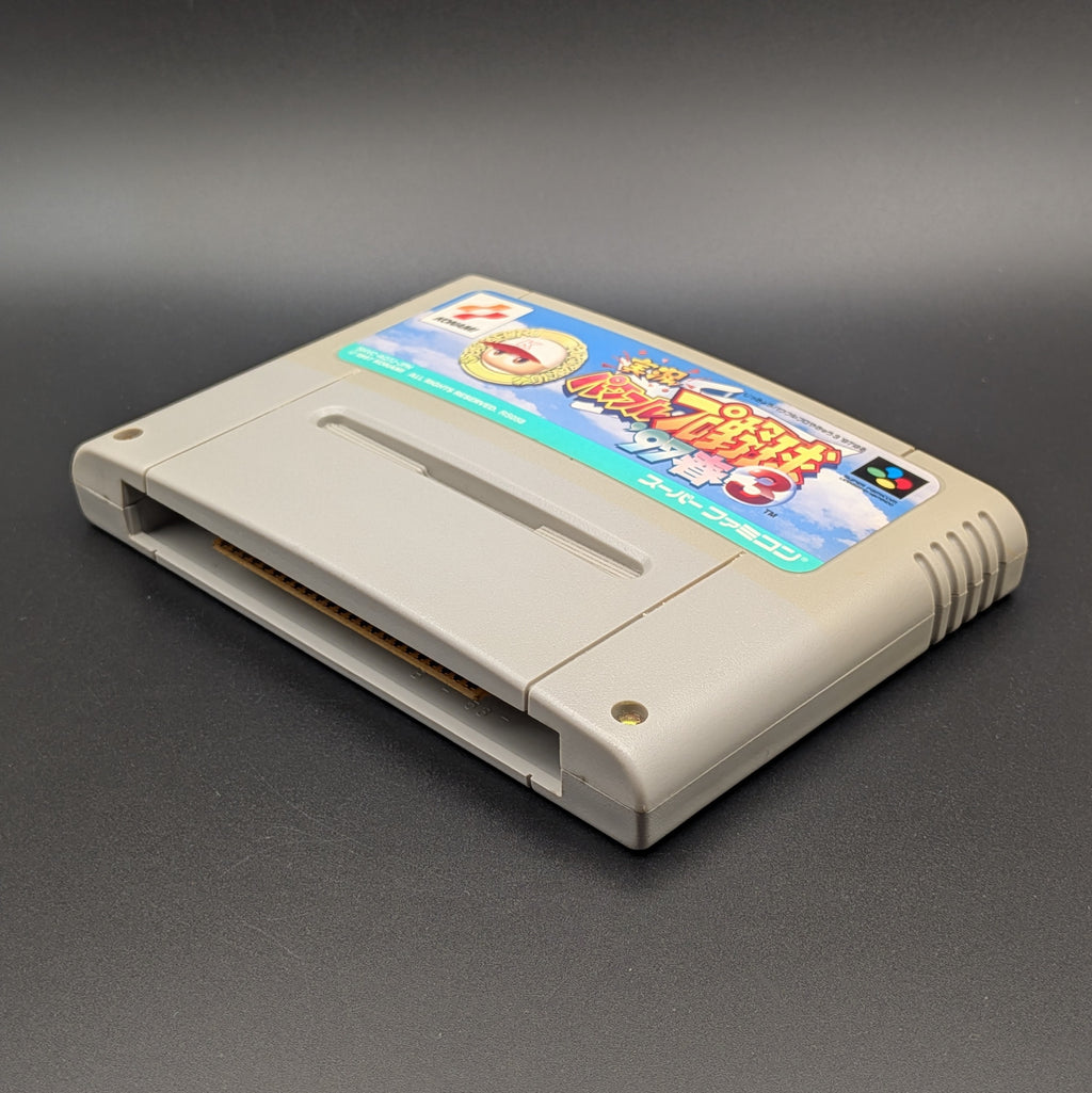Jikkyou Powerful Pro Yakyuu 3 '97 video game cartridge for Nintendo's Super Famicom (SFC) Entertainment System, shown laying on its back with the label facing upwards. Showing the right hand side and bottom slot. It sits on a dark grey background