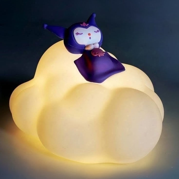 A cloud-shaped LED night light glowing with warm yellow light, featuring a small purple cartoon character figurine sitting on top against a dark background.