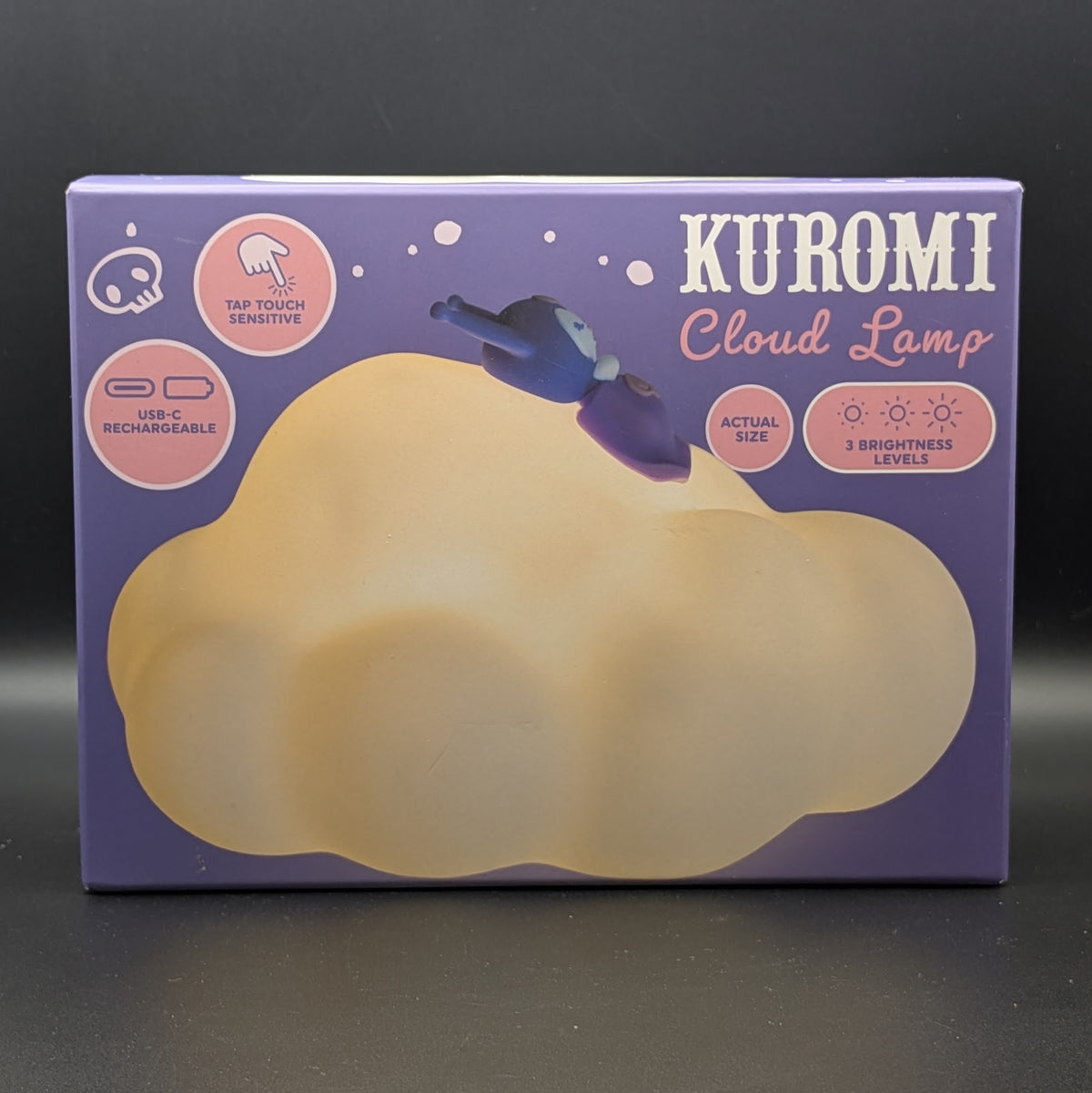 A purple retail box for a Kuromi Cloud Lamp, featuring a large beige cloud graphic and pink circular feature callouts on a dark gray background.