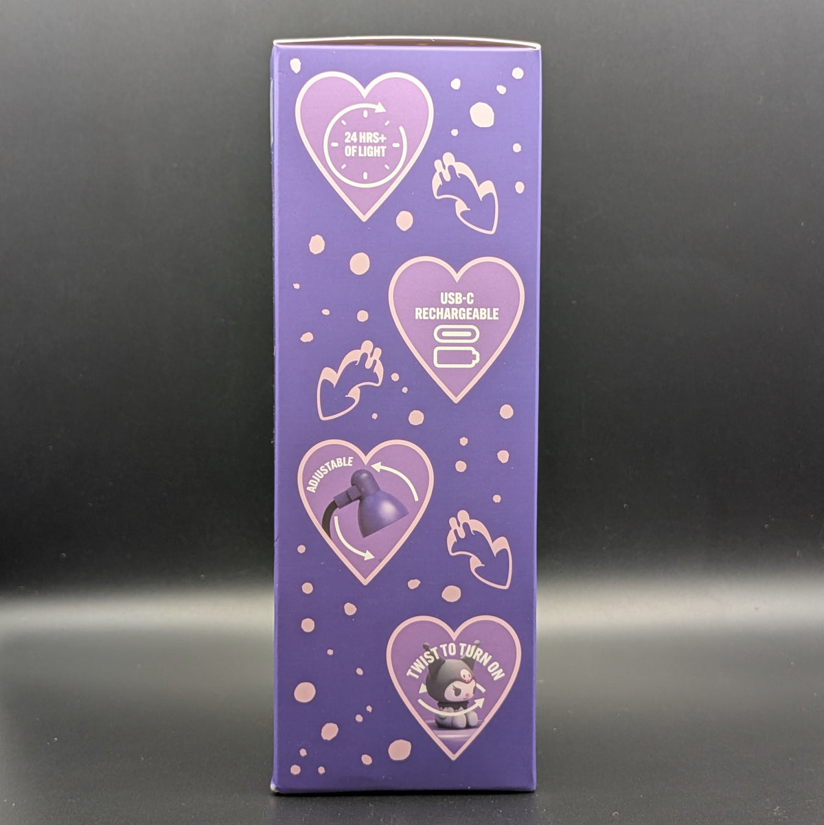 A tall purple product box standing upright against a dark gray background. The box features light pink heart graphics with icons and text including '24-HRS OF LIGHT', 'USB-C RECHARGEABLE', 'ADJUSTABLE', and 'TWIST TO TURN ON'.