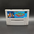 Mickey's Magical Adventure video game cartridge for Nintendo's Super Famicom (SFC) Entertainment System, shown standing up and facing forwards on a dark grey background.