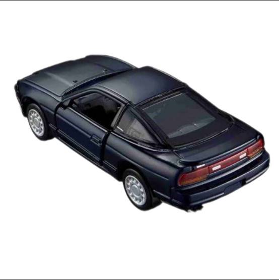A dark metallic toy model car, resembling a Nissan, shown from a three-quarters rear angle on a plain white background.