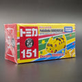 A boxed Tomica toy Pikachu bus, packaged on a dark gray background. The box is wrapped in clear plastic and features a bright yellow front with a yellow Pikabus illustration, large red '151' text, and Takara Tomy branding.