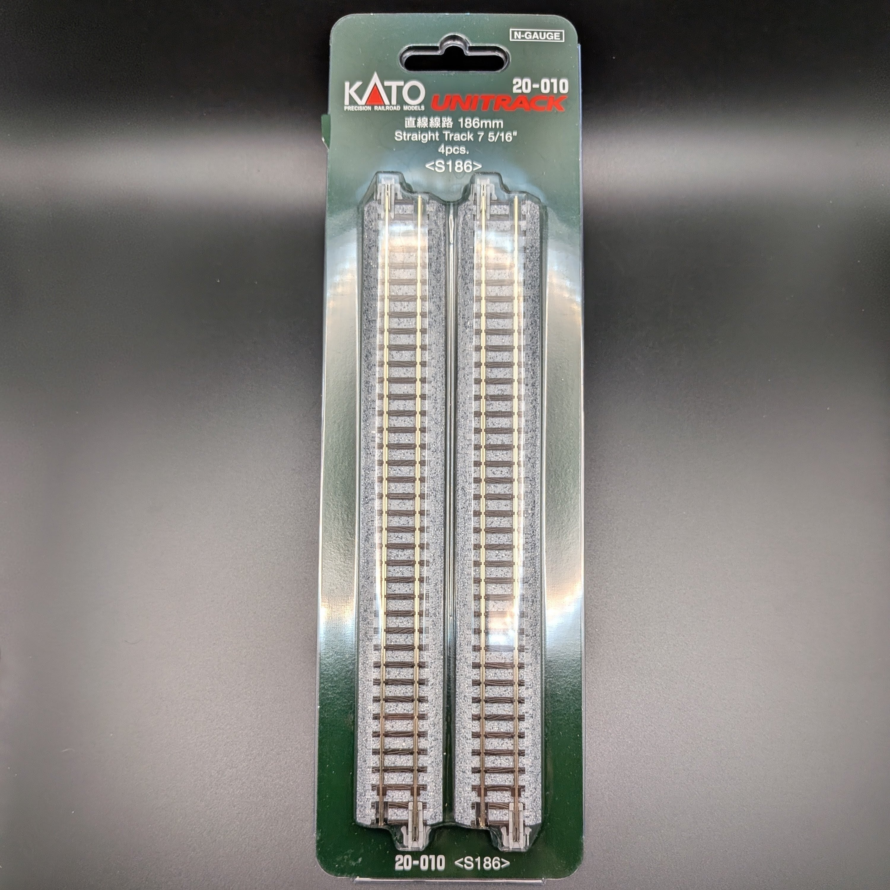 Kato Unitrack 20-010 S186 — Straight Track, N-gauge (Pack of 4). Item is shown face on, allowing you to see information at the top and pieces of track through the clear outer packaging.