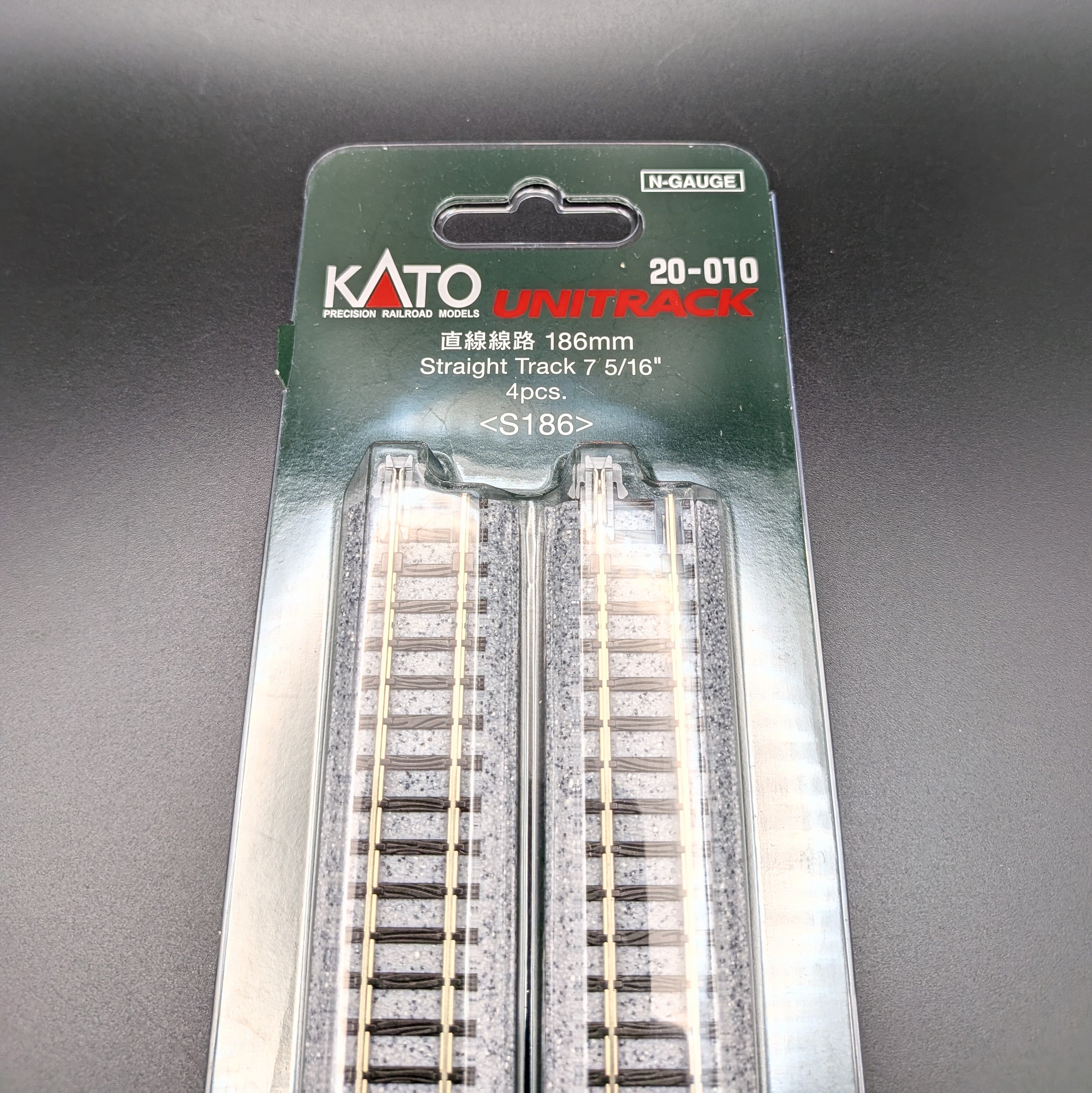 Kato Unitrack 20-010 S186 — Straight Track, N-gauge (Pack of 4). A close-up of the top half of the package so you see the Item information and parts of track through the clear outer packaging.