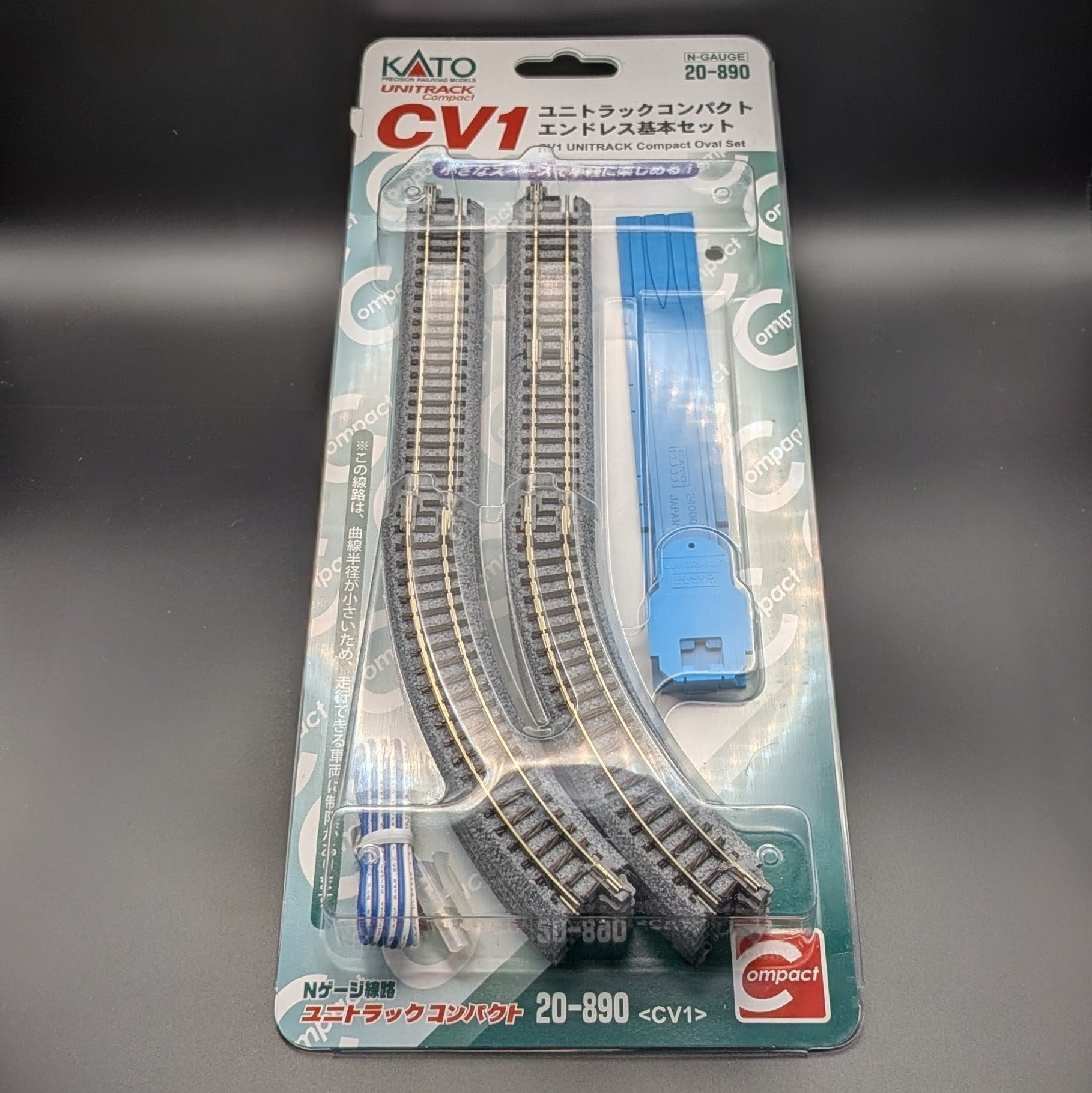Kato CV1 Unitrack Compact Complete track Set (model 20-890) in its original packaging, featuring the parts to make a complete oval track and sat on a lack background.