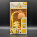 Pompompurin mini desk lamp in its original retail packaging, featuring a yellow character lamp and a flexible yellow cord under a peach-colored shade, with a white and yellow grid-patterned box.
