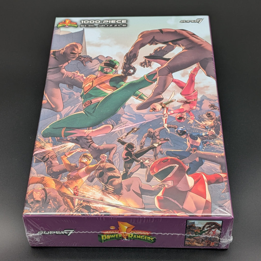 A 1000-piece Power Rangers jigsaw puzzle from Super7, still sealed in its original purple plastic shrink wrap. The box features a highly detailed, colorful illustration of the Power Rangers team in action.
