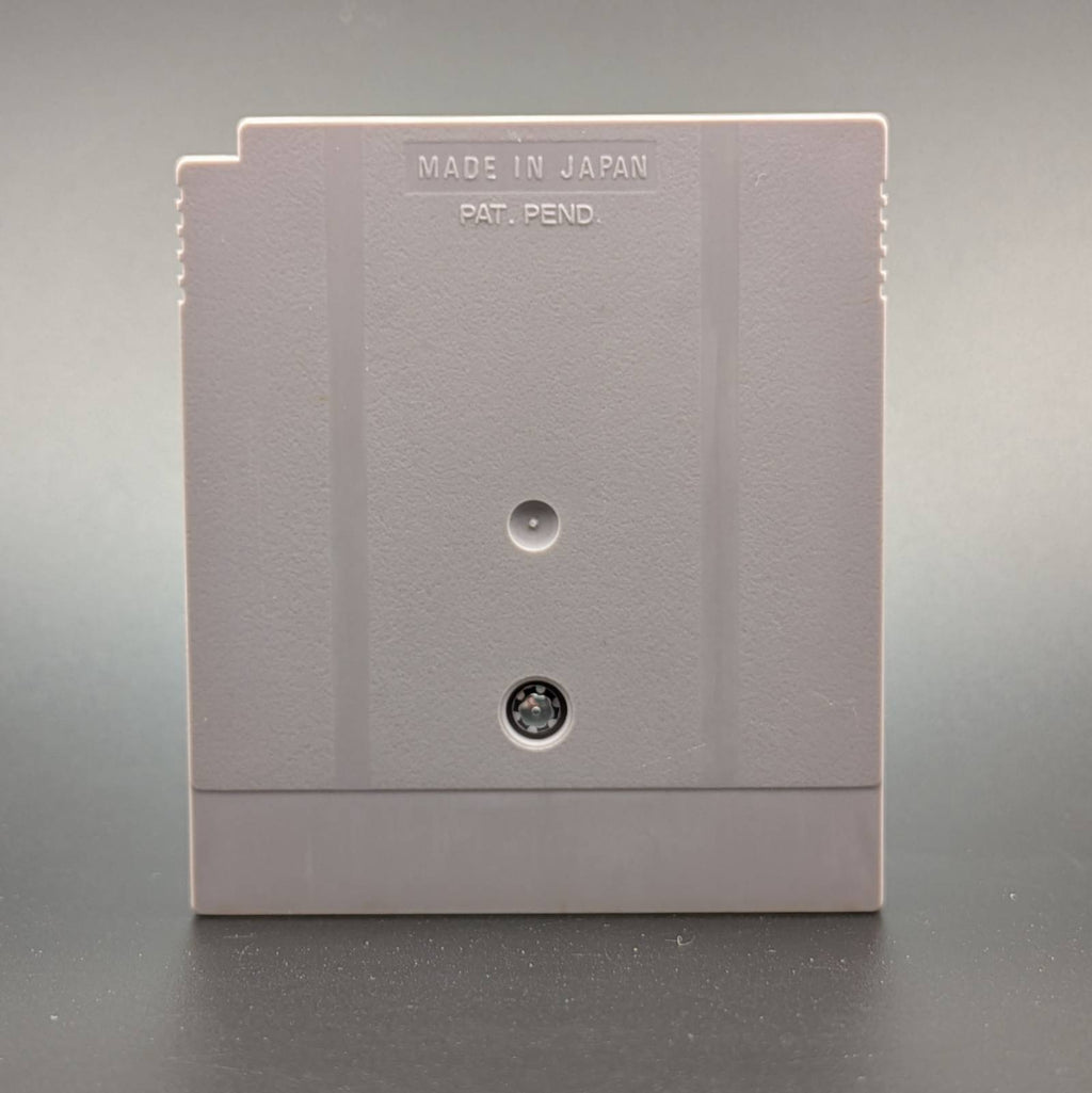 Reverse of a Game Boy Cartridge on a textured surface, featuring the embossed text 'MADE IN JAPAN PAT. PEND.