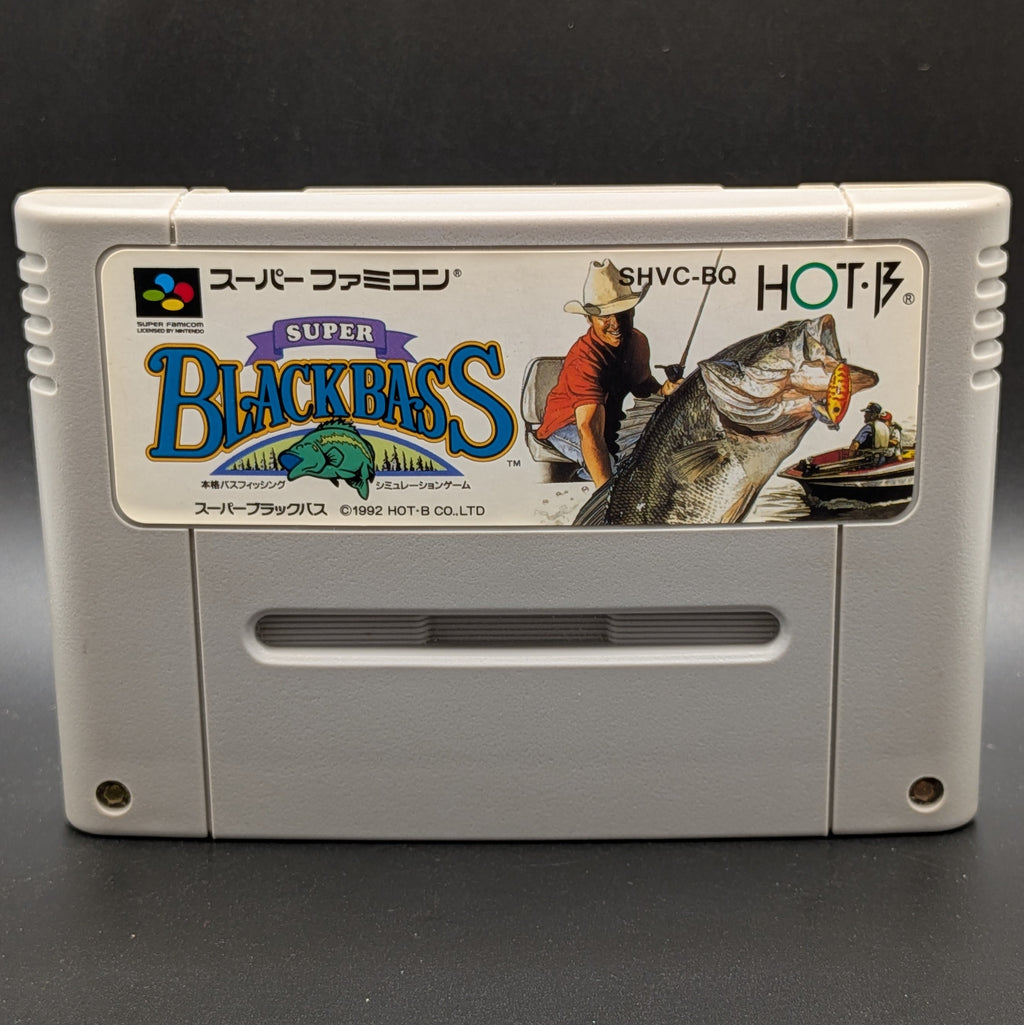A close up of Super Black Bass video game cartridge for Nintendo's Super Famicom (SFC) Entertainment System, shown standing up and facing forward on a dark grey background.
