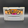 Super Bomberman video game cartridge for Nintendo's Super Famicom (SFC) Entertainment System, shown standing up and facing forwards on a dark grey background.