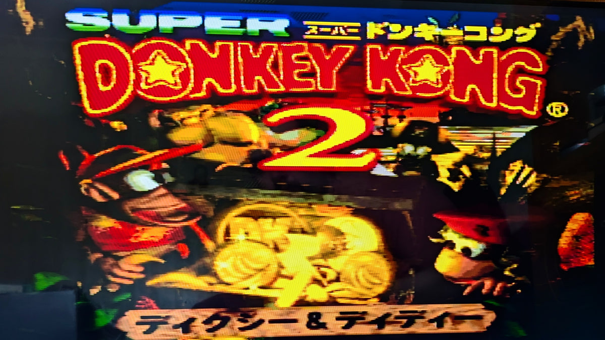Super Donkey Kong 2 for the Super Famicom's digital title screen with colourful title text, Donkey Kong artwork, and Japanese text. This shows tthe  game in working order.