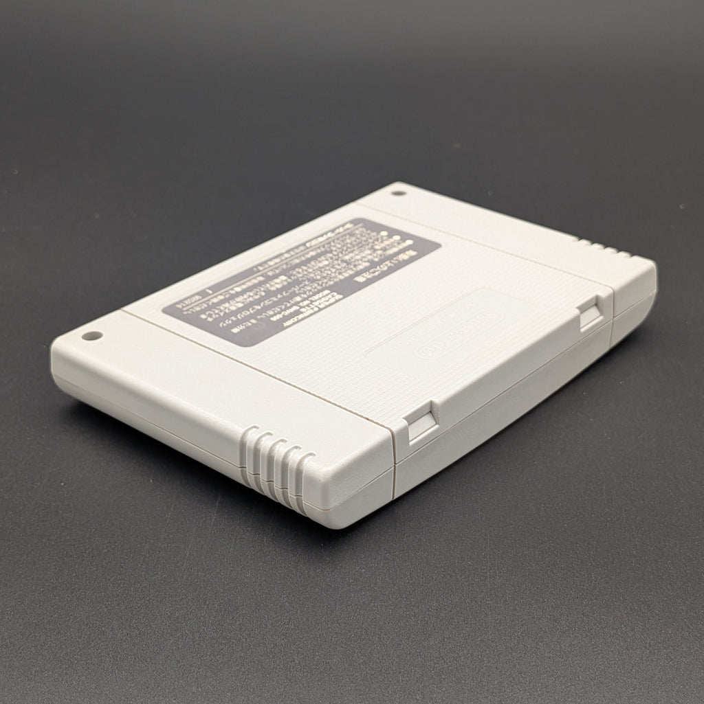 Super Bomberman 3 video game cartridge for Nintendo's Super Famicom (SFC) Entertainment System, showing the back of the cartridge. It sits on a dark grey background.