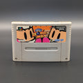 Super Bomberman video game cartridge for Nintendo's Super Famicom (SFC) Entertainment System, shown standing up and facing forwards on a dark grey background.