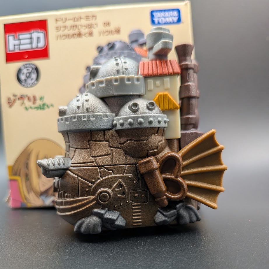 Howls Moving Castle Tomica Dream  Model No.8 - Right side view with the box behind, on a black background.