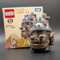 Howls Moving Castle Tomica Dream  Model No.8 - Front View with box behind, on a black background.