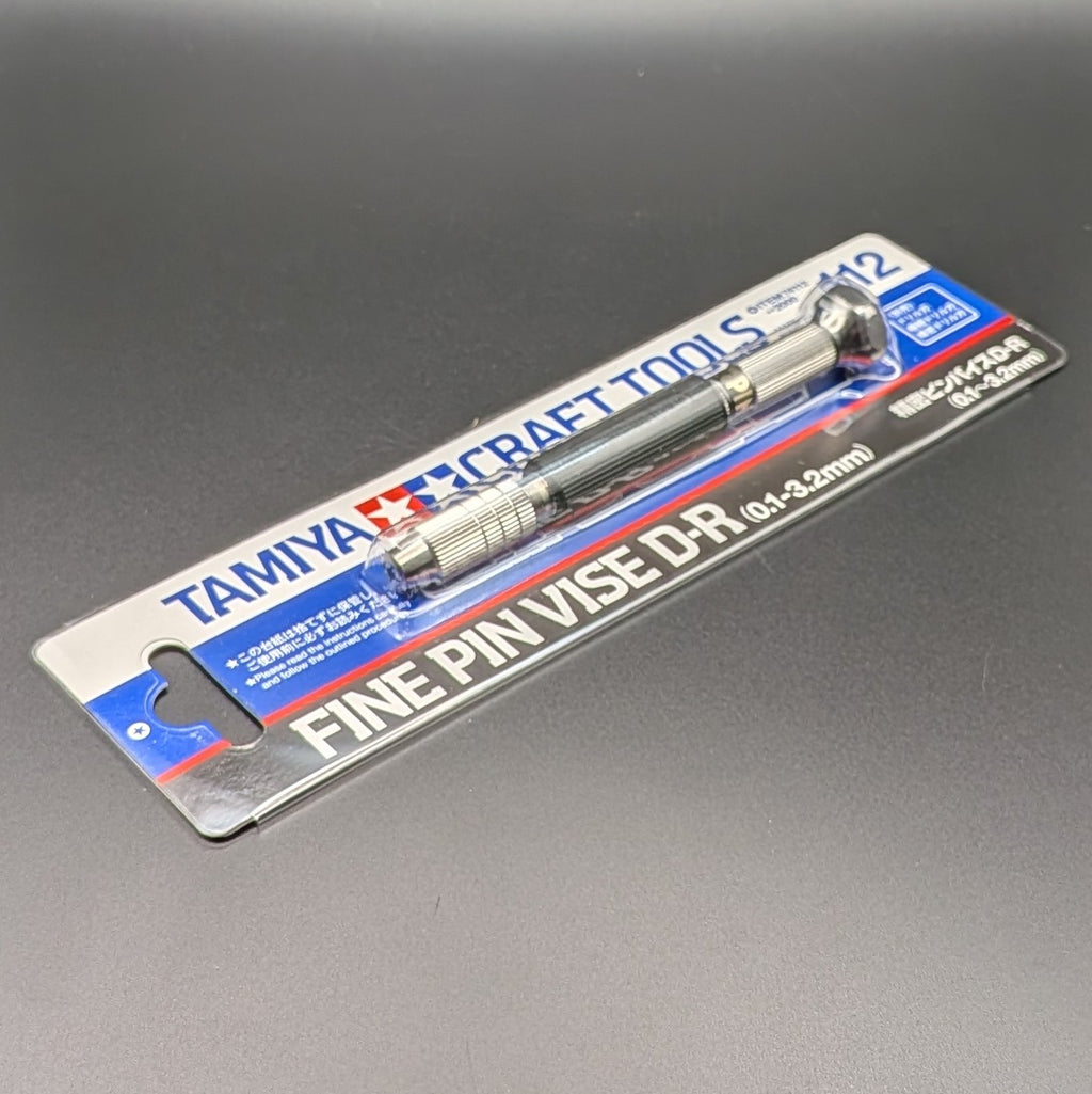 Tamiya 74112 Fine Pin Vise D-R (0.1-3.2mm) in its original blister card packaging, displayed on a dark gray background.