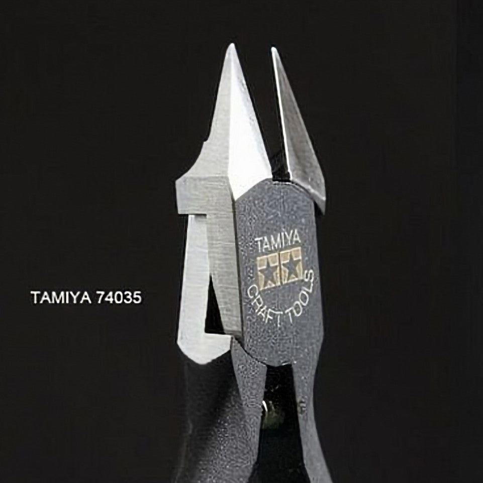 Tamiya 74035 diagonal Sharp Pointed Side Cutter with a textured dark gray handle and silver metal jaws, shown against a solid black background with the model number printed on the left.