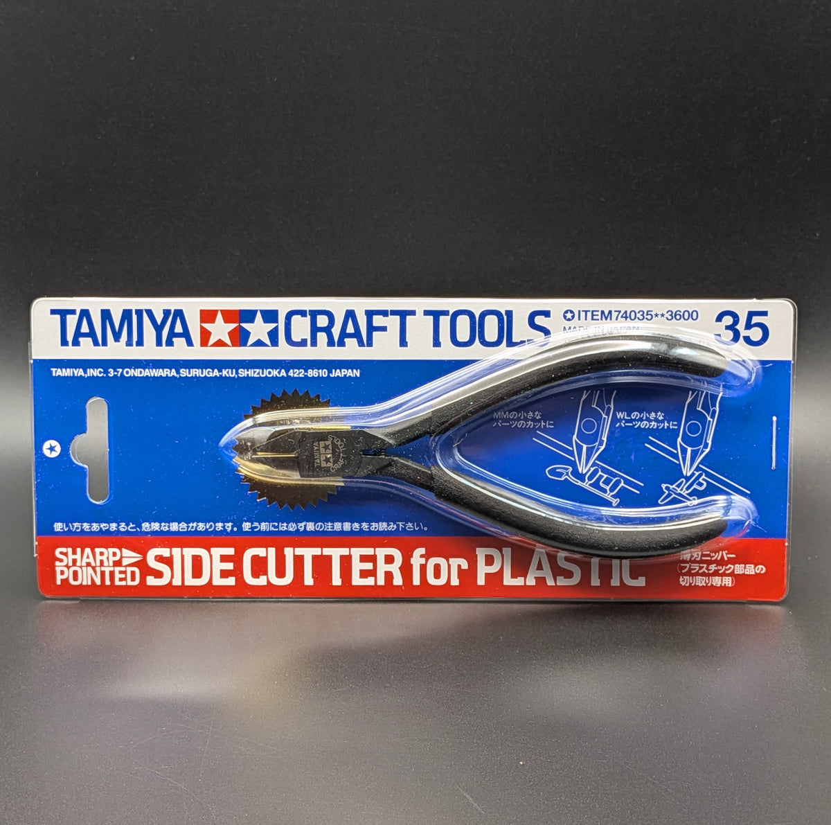 Tamiya Craft Tools Sharp Pointed Side Cutter for Plastic, model 74035 in its original blue and red retail blister packaging, shown side on against a dark grey background.