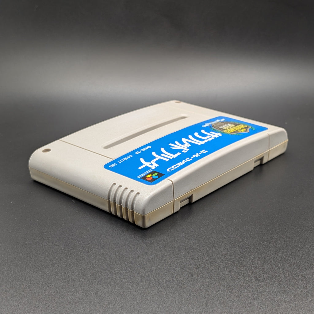 Thoroughbred Breeder video game cartridge for Nintendo's Super Famicom (SFC) Entertainment System, shown laying on its back with the label facing up and the top edge is visible. Pictured on a dark grey background.